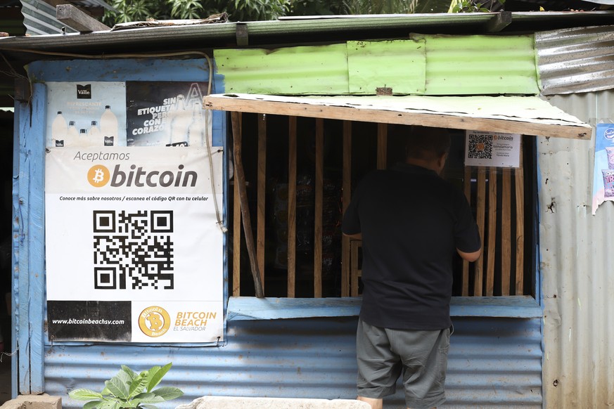 A worker at Hope House, an organization that sponsors the use of cryptocurrencies in El Zonte beach, makes a purchase at a small store that accepts Bitcoin, in Tamanique, El Salvador, Wednesday, June  ...