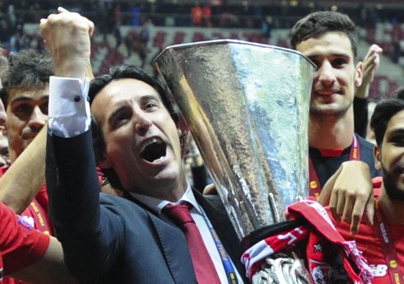 Sevilla&#039;s head coach Unai Emery holds the trophy after Sevilla won 3-2 during the final of the soccer Europa League between FC Dnipro Dnipropetrovsk and Sevilla FC at the National Stadium in Wars ...