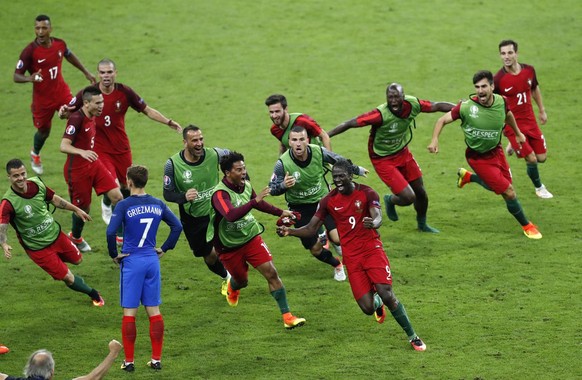 2016 AP YEAR END PHOTOS - Portugal&#039;s Eder, front right, celebrates after scoring the opening goal during the Euro 2016 final soccer match between Portugal and France at the Stade de France in Sai ...