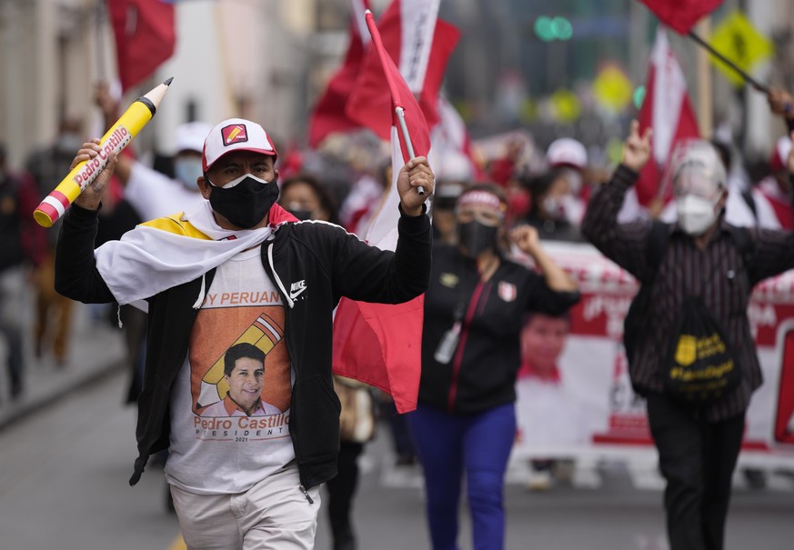 Supporter of presidential candidate Pedro Castillo march in Lima, Peru, Wednesday, June 9, 2021. Peruvians are still waiting to learn who will become their president next month as votes from Sunday&#0 ...