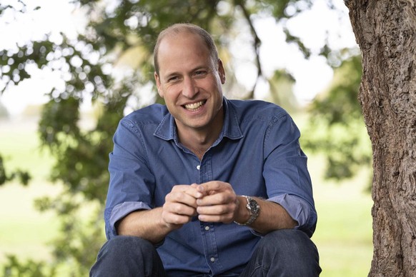 In this undated photo issued by Kensington Palace on Saturday, Oct. 10, 2020, Prince William sits under the canopy of an oak tree during a recording to promote the first TED conference, in the grounds ...