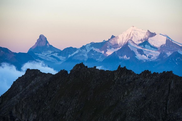 The Matterhorn mountain, left, and the Weisshorn moutain, right, after sunrise with the view out of Eggishorn moutain, in Fiesch, Switzerland, early Tuesday, July 28, 2015. (KEYSTONE/Dominic Steinmann ...
