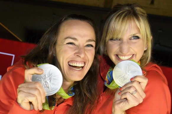 Timea Bacsinszky, right, and Martina Hingis, left, pose with their silver medal in the women&#039;s Tennis Doubles tournament during a medal celebration celebrating in the House of Switzerland at the  ...