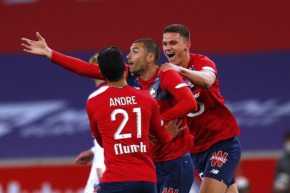 Lille&#039;s Burak Yilmaz, center, reacts after scoring during their French League One soccer match between Lille and Nice in Villeneuve d&#039;Ascq, northern France, Saturday May. 1, 2021. (AP Photo/ ...