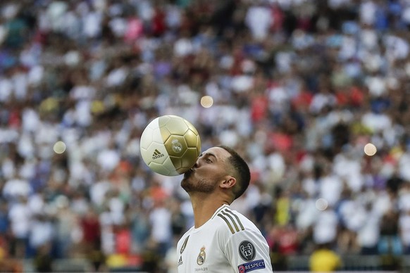 Belgium forward Eden Hazard kisses the ball during his official presentation after signing for Real Madrid at the Santiago Bernabeu stadium in Madrid, Spain, Thursday, June 13, 2019. Real Madrid annou ...