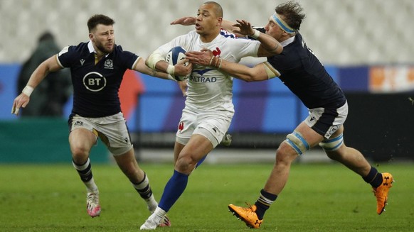 epa09100297 Gael Fickou (C) of France, Jamie Ritchie (R) and Ali Price (L) of Scotland in action against during the Rugby Six Nations match between France and Scotland in Saint-Denis, outside Paris, F ...