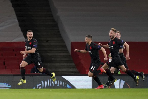 Slavia Prague&#039;s Tomas Holes, left, celebrates after scoring his side&#039;s first goal during the Europa League quarterfinal soccer match between Arsenal and Slavia Prague at Emirates stadium in  ...