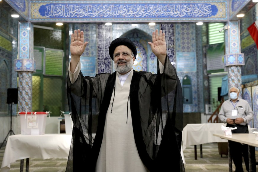 Ebrahim Raisi, a candidate in Iran&#039;s presidential elections waves to the media after casting his vote at a polling station in Tehran, Iran Friday, June 18, 2021. Iran began voting Friday in a pre ...