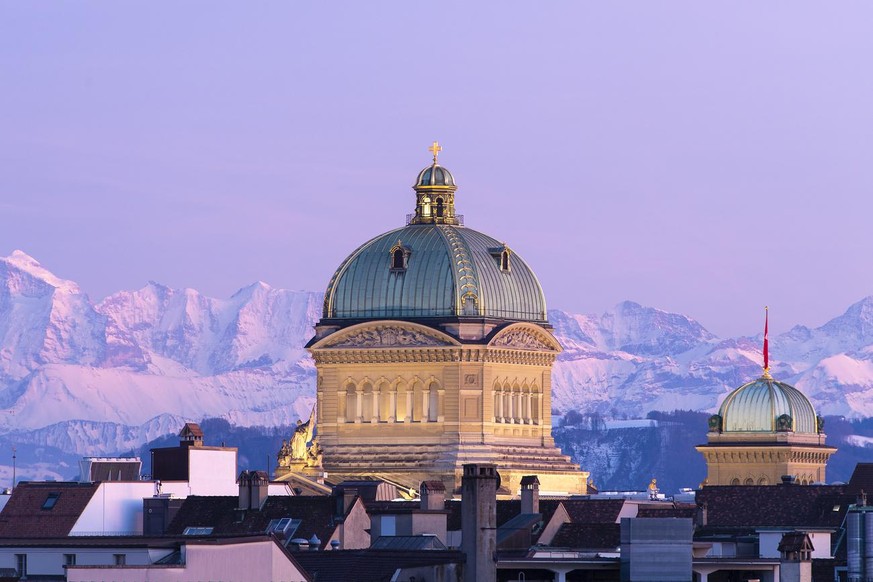 The Federal Palace pictured during the sunset with a beautiful view of the Alps, in Bern, Switzerland, Wednesday, February 13, 2019. (KEYSTONE/Anthony Anex)