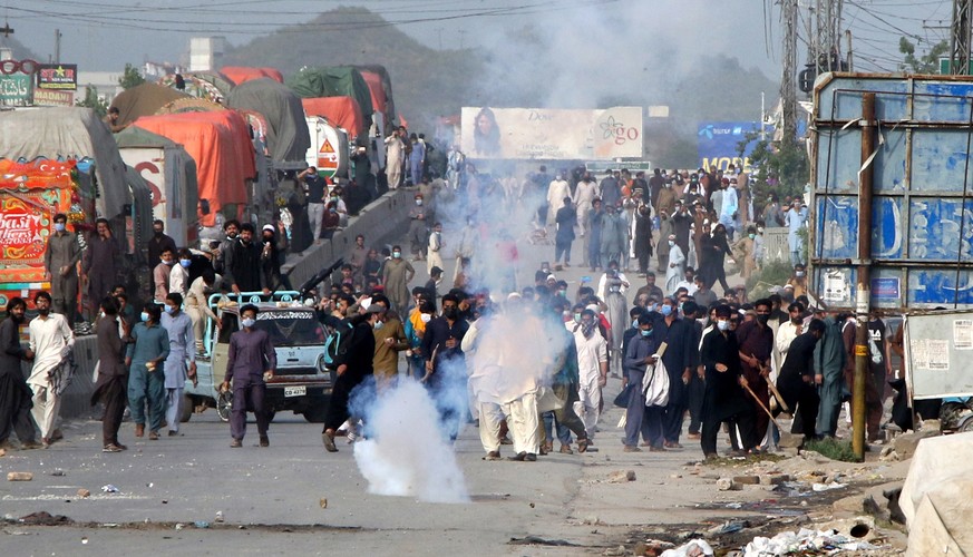 epa09133042 policemen fire teargas shell to supporters of Islamic political party Tehreek-e-Labbaik Pakistan (TLP), during a protest after they blocked a road to demand the release of their leader Saa ...