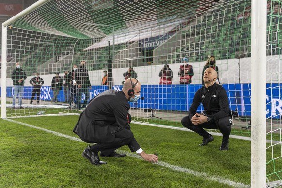 Officials measure the replacement goal, after the original one was found to be deficient ahead of the FIFA World Cup Qatar 2022 qualifying Group C soccer match between Switzerland and Lithuania, at th ...