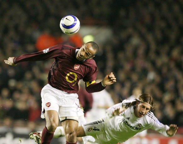 Arsenal&#039;s Thierry Henry (L) and Real Madrid&#039;s Sergio Ramos challenge for the ball during their Champions League last 16 soccer match at Highbury north London, Wednesday 08 March 2006. EPA/LI ...