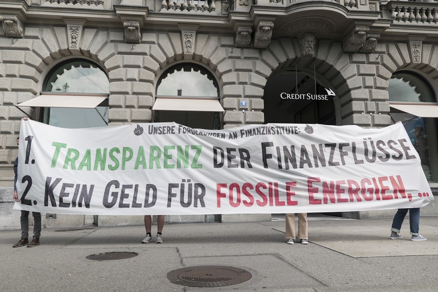 Aktivistinnen und Aktivisten von &quot;Rise Up For Change&quot; stehen mit einem Transparent vor der Grossbank Credit Suisse (CS), aufgenommen am Montag, 26. Juli 2021 in Zuerich. Klimaaktivisten habe ...