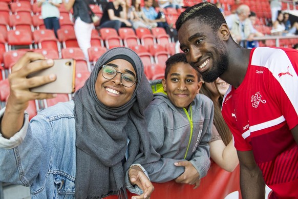 Swiss defender Johan Djourou makes a selfie with a fan during the Swiss soccer national team training session, at the Stadium Maladiere, in Neuchatel, Switzerland, Wednesday, May 24, 2017. Switzerland ...