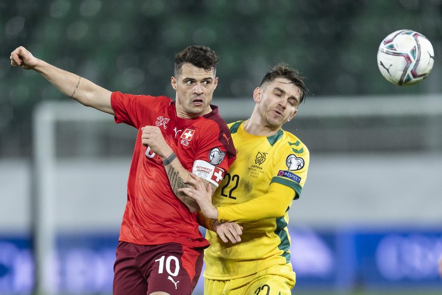 Switzerland&#039;s Granit Xhaka, left, fights for a header against Lithuania&#039;s Fedor Cernych during the FIFA World Cup Qatar 2022 qualifying Group C soccer match between Switzerland and Lithuania ...