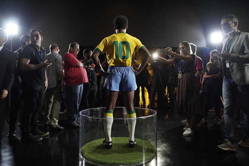 Journalists stand around the statue of legendary Brazilian player Pele at the Brazilian Soccer Team Museum in Rio de Janeiro, Brazil, Thursday, Feb. 20, 2020. The Brazilian Football Confederation unve ...