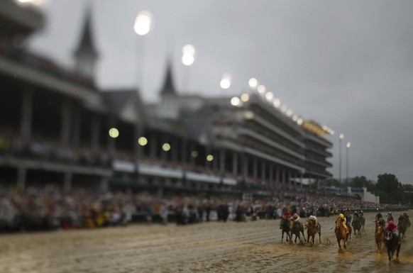 In this photo made with a tilt shift lens, Luis Saez rides Maximum Security across the finish line first during the 145th running of the Kentucky Derby horse race at Churchill Downs on May 4, 2019 in  ...