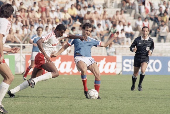 French team Captain Michel Platini is tackled by Canada&#039;s Randy Samuel, left, during the Group C France Vs. Canada match of the Football World Cup, on June 1, 1986, in Leon, Mexico. France defeat ...