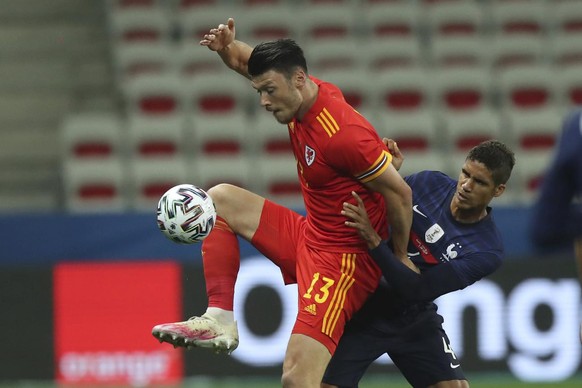 Wales&#039; Kieffer Moore, left, is challenged by France&#039;s Raphael Varane during the international friendly soccer match between France and Wales at the Allianz Riviera stadium in Nice, France, W ...
