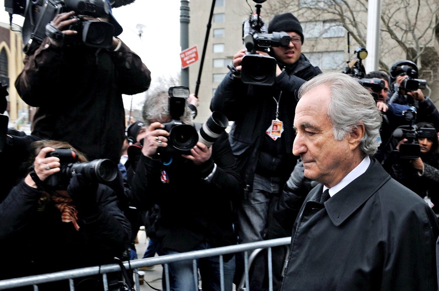 epa09135067 (FILE) - Financier Bernard Madoff (R) exits Federal Court in New York, New York, USA, 11 March 2009 (reissued 14 April 2021). Madoff has died in prison aged 82, the Federal Bureau of Priso ...