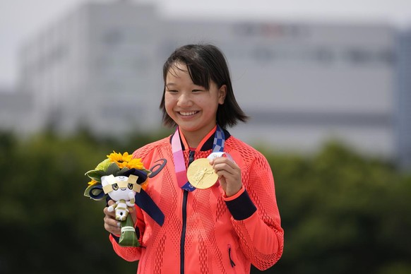 Gold medal winner Momiji Nishiya of Japan holds her medal after winning the women&#039;s street skateboarding finals at the 2020 Summer Olympics, Monday, July 26, 2021, in Tokyo, Japan. (AP Photo/Ben  ...