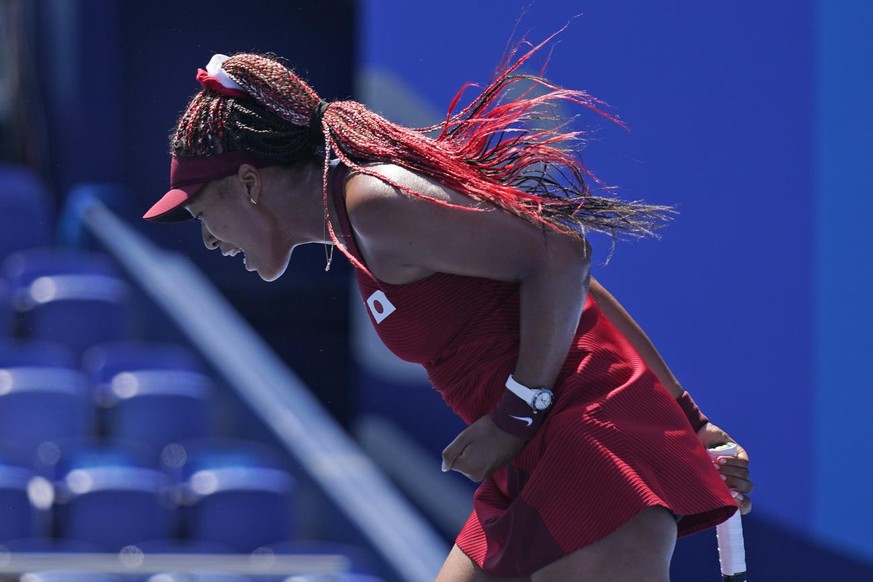 Naomi Osaka, of Japan, reacts during the first round of the tennis competition at the 2020 Summer Olympics, Sunday, July 25, 2021, in Tokyo, Japan. (AP Photo/Seth Wenig)