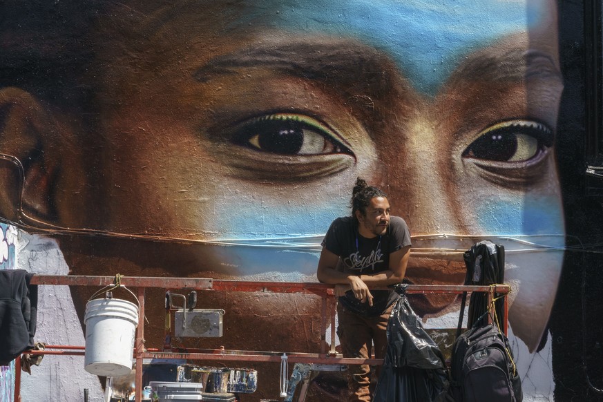 Painter and muralist Michael Draghi pauses next to his new mural of Amanda Gorman, a former national youth poet laureate, in the Melrose neighborhood of Los Angeles on Friday, April 2, 2021. A quote b ...