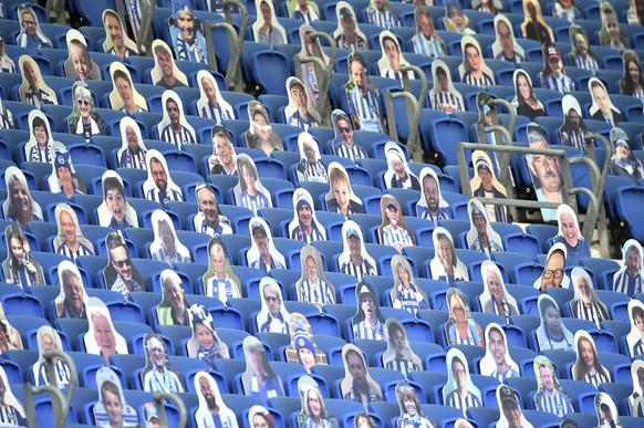 Cutout photos of Brighton fans fill the empty stands during the English Premier League soccer match between Brighton and Newcastle United at the American Express Community Stadium in Brighton, England ...