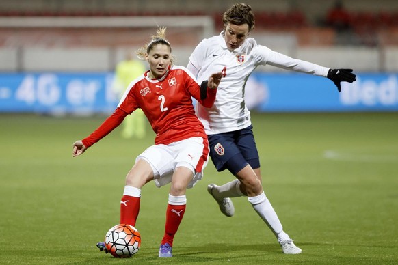 Switzerland&#039;s Sandrine Mauron, left, fights for the ball with Norway&#039;s Ingvild Stensland, right, during the match between Switzerland and Norway at UEFA Women&#039;s qualifying tournament fo ...