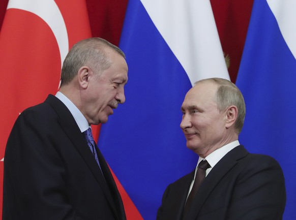 Russia&#039;s President Vladimir Putin, right, and Turkish President Recep Tayyip Erdogan shake hands after a joint news conference followed six-hour talks in the Kremlin, in Moscow, Russia, Thursday, ...