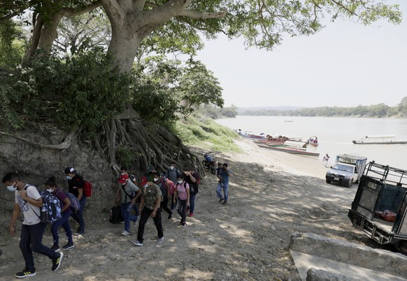Migrants walk into Mexico after crossing the Usumacinta River from Guatemala aboard a motorboat, in Frontera Corozal, Chiapas state, Mexico, Wednesday, March 24, 2021. (AP Photo/Eduardo Verdugo)