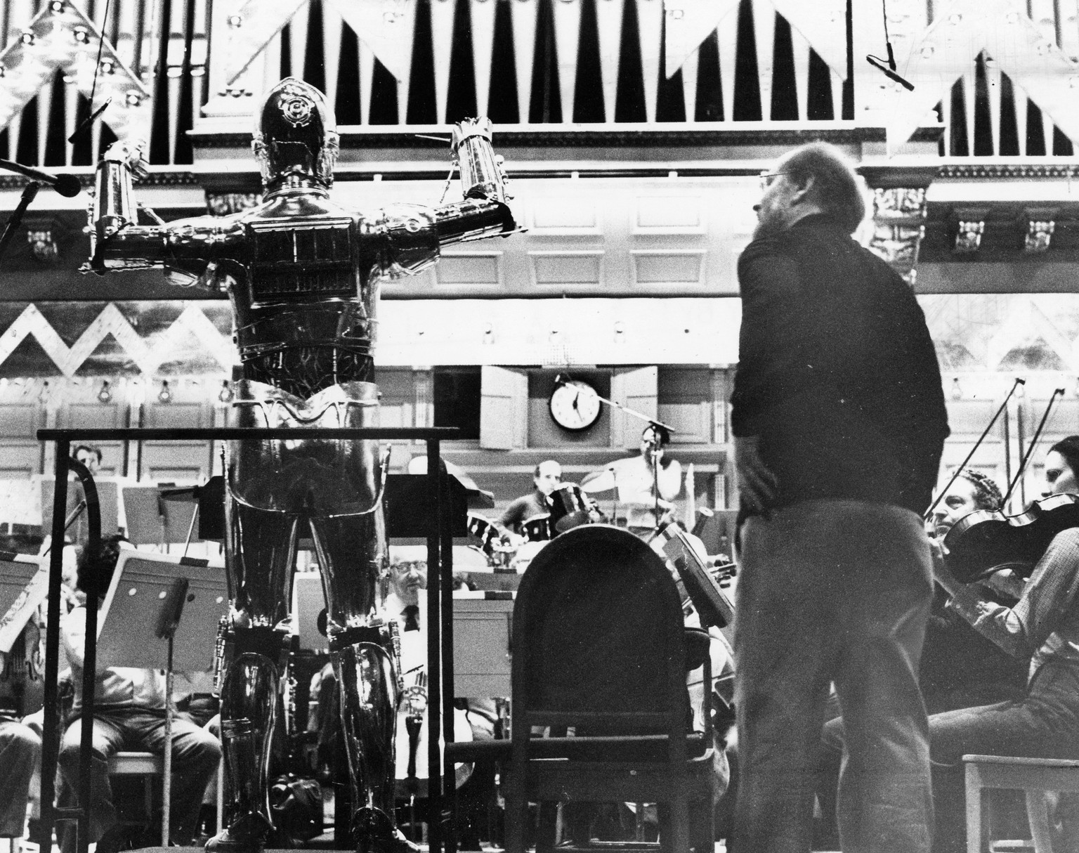 Boston Symphony Orchestra&#039;s Boston Pops in 1980
BOSTON - APRIL 29: New Boston Pops conductor John Williams looks on as Star Wars character C3PO conducts the Pops during a rehearsal in Boston on A ...