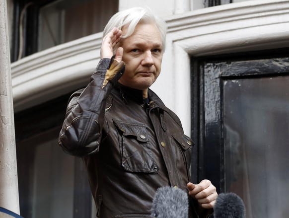 FILE - In this May 19, 2017 file photo, WikiLeaks founder Julian Assange greets supporters from a balcony of the Ecuadorian embassy in London. Ecuadorean officials announced Wednesday, March 28, 2018, ...