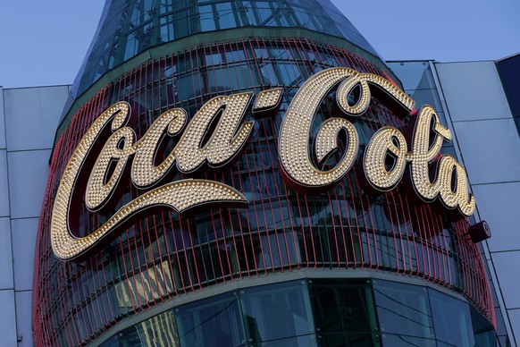 In this Feb. 4, 2021, photo, a lighted sign adorns the Coca-Cola Store in Las Vegas. The resurgent coronavirus slowed Coca-Cola���s recovery in the fourth quarter, and the company said the slump has c ...