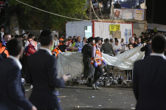 epa09168829 Israeli security officials and rescuers inspect the dead bodies of dozens of Ultra-Orthodox Jews who died during an event at a revelry complex during Lag Ba&#039;Omer; in Mount Meron, Isra ...