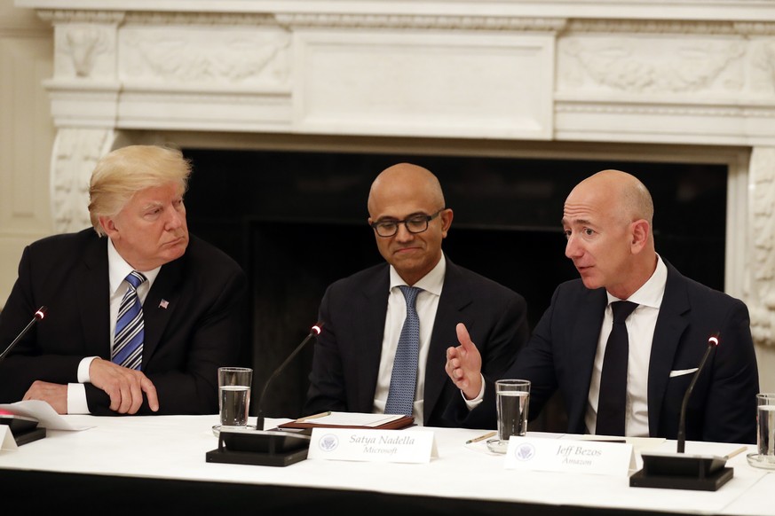FILE - In this June 19, 2017, file photo President Donald Trump, left, and Satya Nadella, Chief Executive Officer of Microsoft, center, listen as Jeff Bezos, Chief Executive Officer of Amazon, speaks  ...