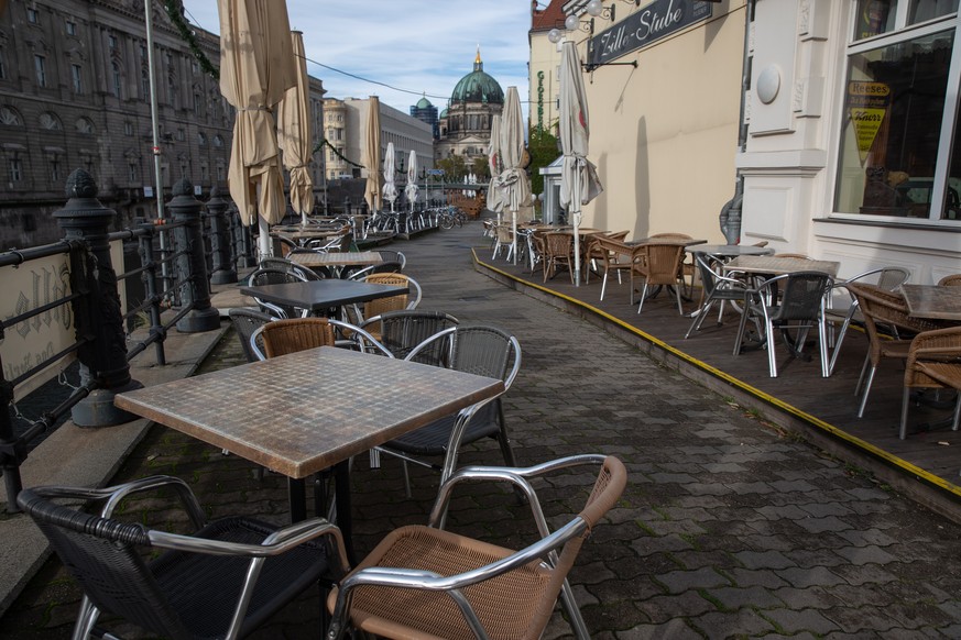 epa08792887 Empty outdoor tables and chairs stand as restaurants stay closed at the Spreeufer near the Berlin Cathedral, in Berlin, Germany, 02 November 2020. Germany imposed a month-long nationwide p ...