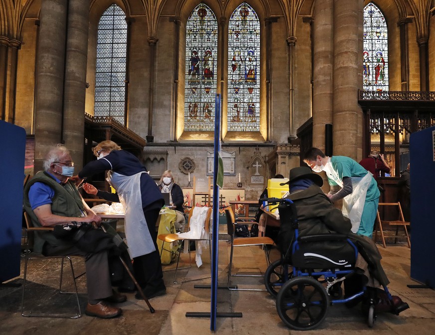 People recieve their Pfizer-BioNTech vaccination inside Salisbury Cathedral in Salisbury, England, Wednesday, Jan. 20, 2021. Salisbury Cathedral opened its doors for the second time as a venue for the ...