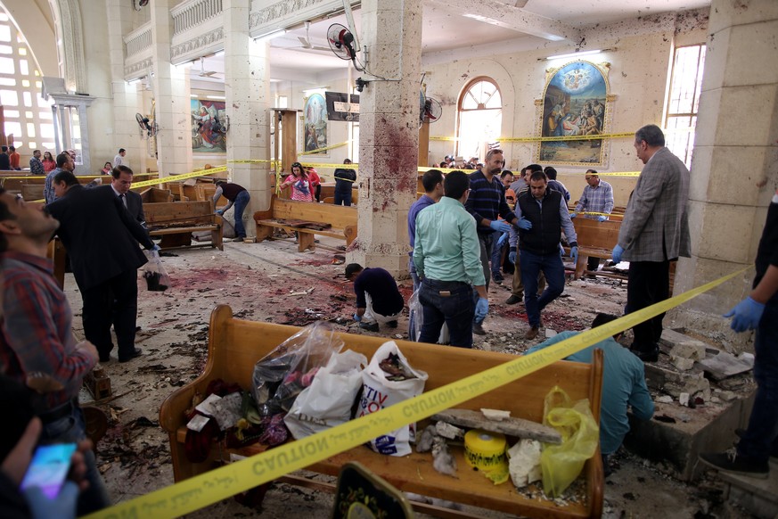 epa05898916 Security personnel investigate the scene of a bomb explosion inside Mar Girgis church in Tanta, 90km north of Cairo, Egypt, 09 April 2017. According to the Egyptian Health Ministry, at lea ...