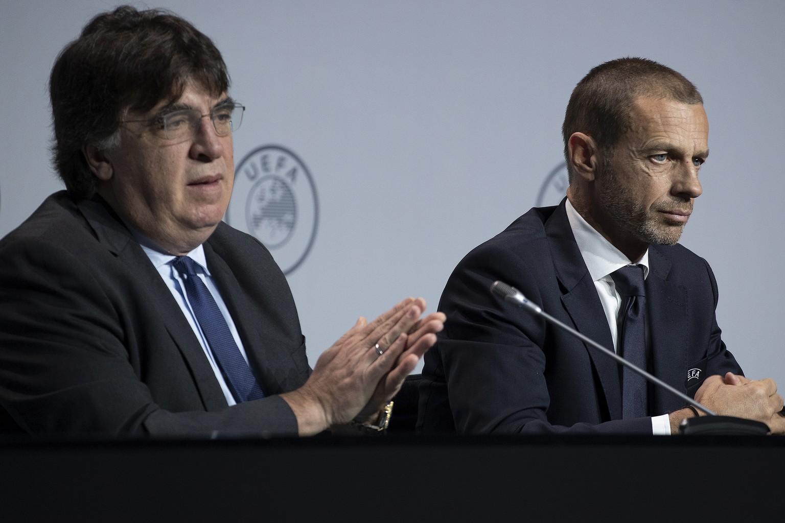UEFA&#039;s Interim General Secretary Theodore Theodoridis, left, washes his hand with a sanitizing gel during a press conference with President Aleksander Ceferin, right, following a meeting of Europ ...