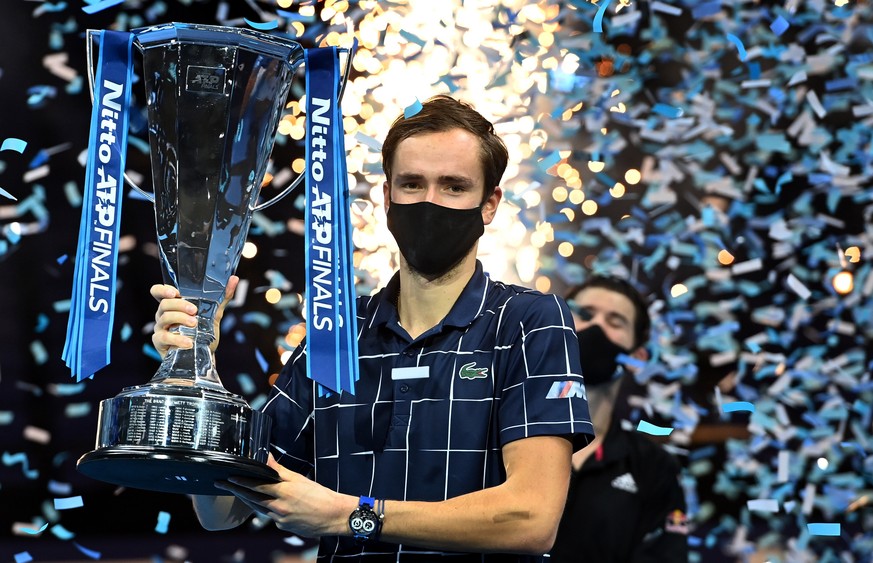 epa08836642 Daniil Medvedev of Russia celebrates with his trophy after winning against Dominic Thiem of Austria their final match at the ATP World Tour Finals tennis tournament in London, Britain, 22  ...