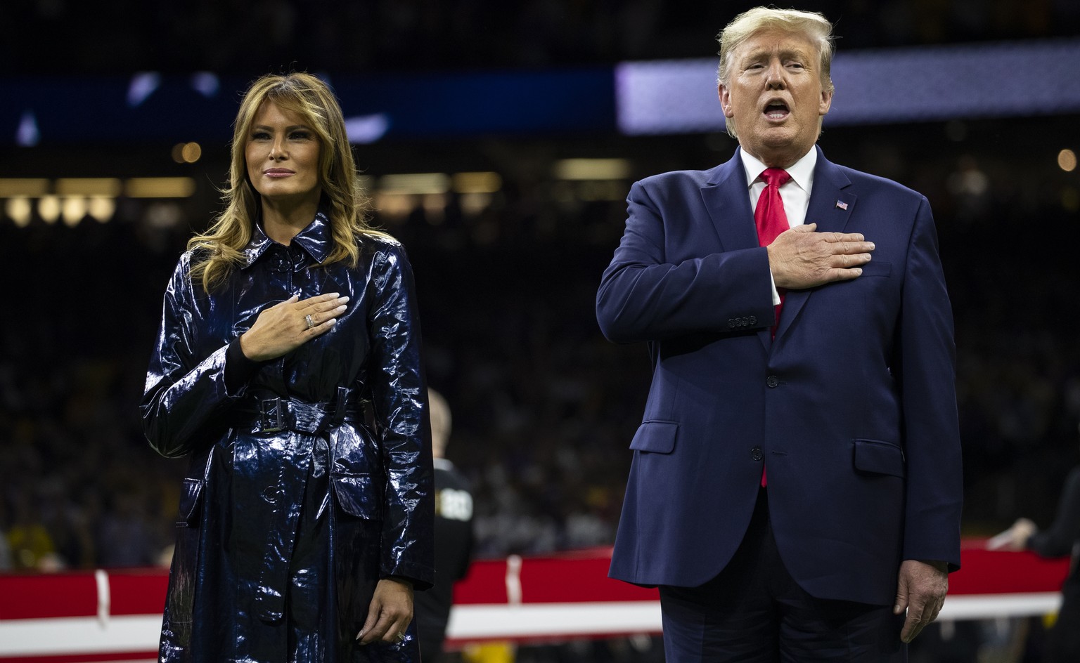 President Donald Trump and first lady Melania Trump stand for the national anthem before the beginning of the College Football Playoff National Championship game between LSU and Clemson, Monday, Jan.  ...