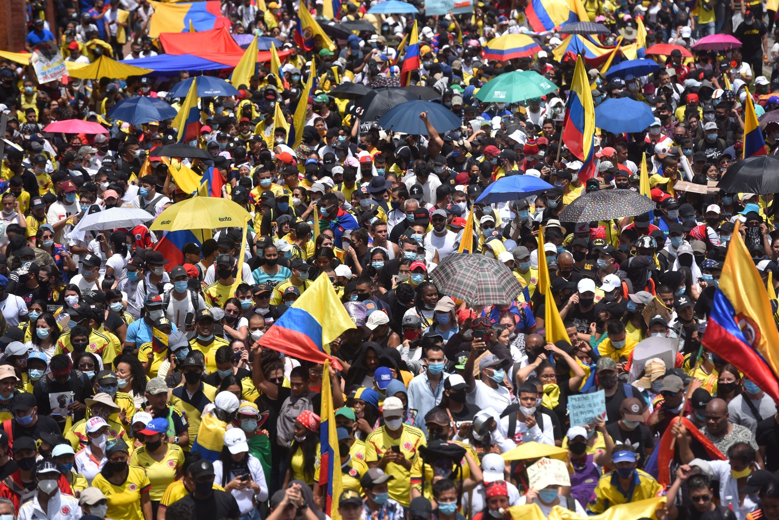 epa09172713 Demonstrators participate in a day of protests against the tax reform as International Workers&#039; Day is commemorated in Cali, Colombia, 01 May 2021. Opposition congressmen and civil so ...