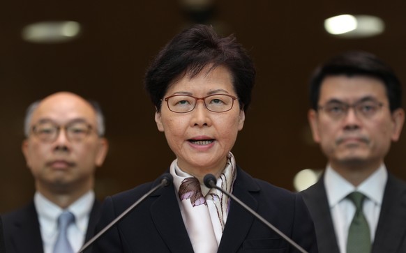 epa07757255 Hong Kong Chief Executive Carrie Lam (C), flanked by Chief Secretary for Administration, Matthew Cheung Kin-chung (L) and the Financial Secretary Paul Chan (R), speaks during a press confe ...