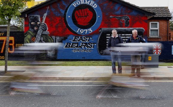 Time Trialists pass a loyalist mural during stage one of the Giro d&#039;Italia in Belfast, Northern Ireland, Friday, May, 9, 2014. The Giro d&#039;Italia will have three stages in Ireland, starting i ...