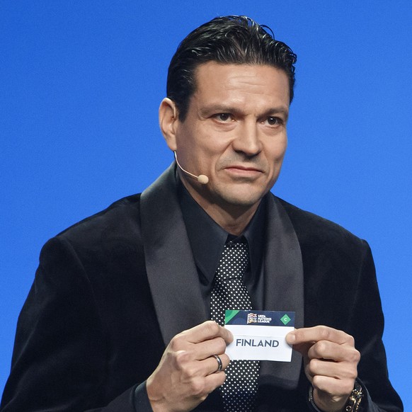 former Finland&#039;s soccer player Jari Litmanen shows the ticket of Finland, during the soccer UEFA Nations League draw, at the SwissTech Convention Center, in Lausanne, Switzerland, Wednesday, Janu ...