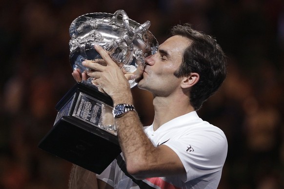 Switzerland&#039;s Roger Federer kisses his trophy after defeating Croatia&#039;s Marin Cilic in the men&#039;s singles final at the Australian Open tennis championships in Melbourne, Australia, Sunda ...