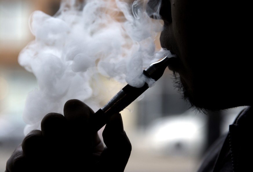 EMBARGOED UNTIL 12:01 AM, TUESDAY, DEC. 16, 2014 0 File - In this April 23, 2014 file photo, an e-cigarette is demonstrated in Chicago. More teens are trying out e-cigarettes than the real thing, acco ...