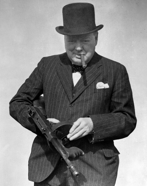 FILE - In this photo Aug. 1, 1940 partly-censored file photo provided by the British government, Britain&#039;s Prime Minister Winston Churchill holds a Tommy Gun during a visit to north-east England. ...