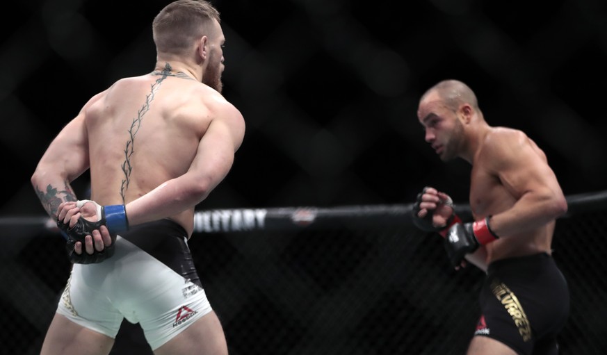 Conor McGregor, left, taunts Eddie Alvarez during a lightweight title mixed martial arts bout at UFC 205, early Sunday, Nov. 13, 2016, at Madison Square Garden in New York. McGregor won the bout. (AP  ...